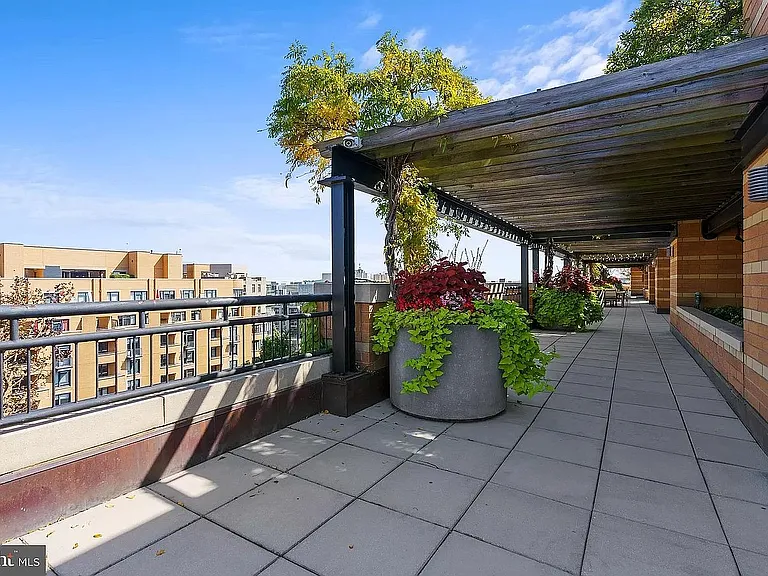 Rooftop entertaining area near grills.