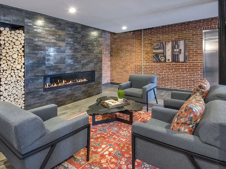 Lobby Seating With Bright Rug And Fireplace.