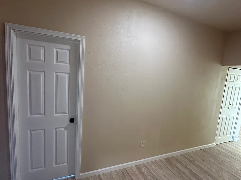 Hallway. Door on the right goes to the Washer dryer. Door on the left goes to a bedroom.