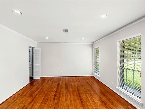 Formal living/dining room with hardwood flooring. Can be used as a large home office/study for those working from home.