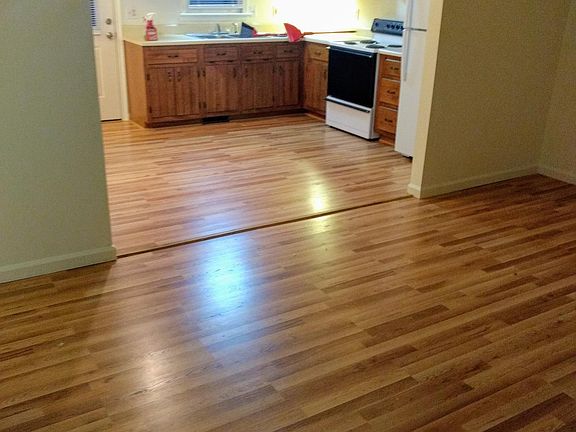 Living room view into kitchen. All paint is WHITE, not off white.