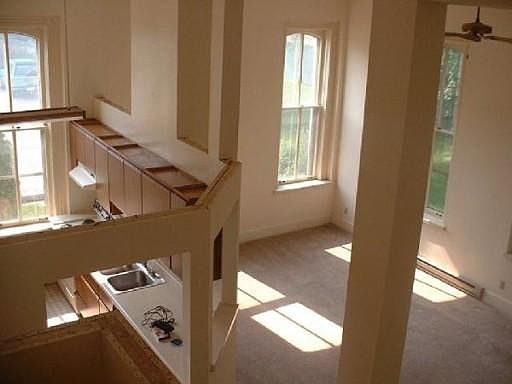 Overhead view of kitchen and living room showing high ceilings.