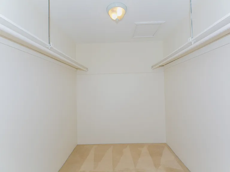 Primary bedroom walk in closet