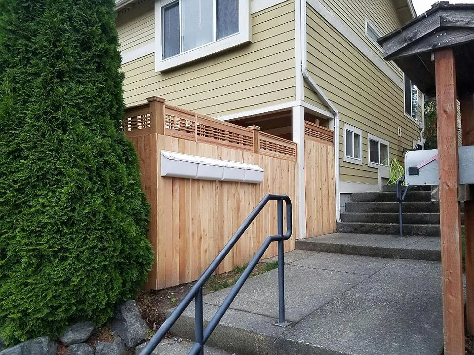 Front of house with gate and mail. 