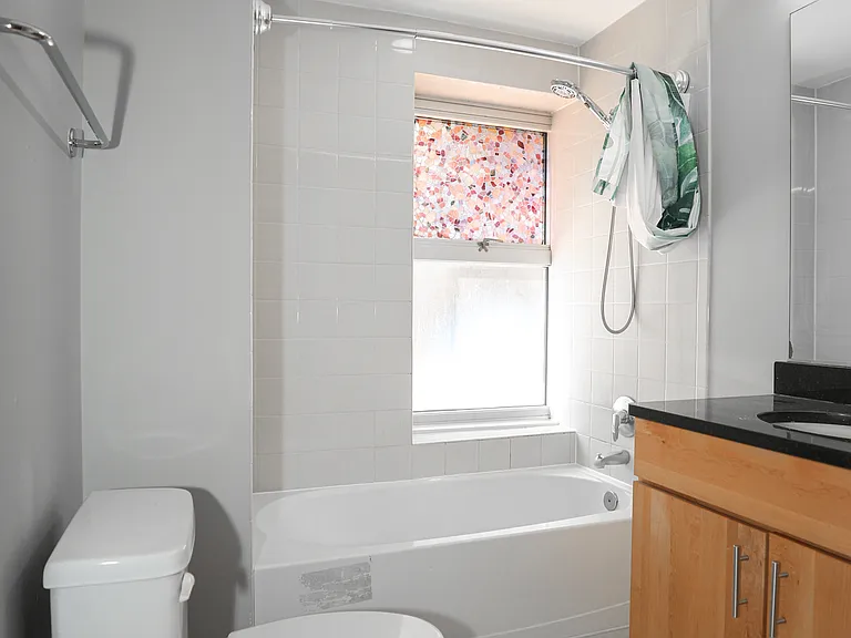 Updated Bathroom with Full Tub, Vanity Storage & Modern Fixtures
