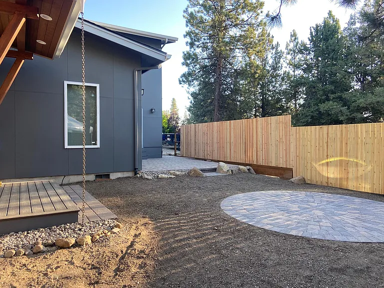 partial backyard and side yard, pre finishing - fence is stained dark and ground covering is in
