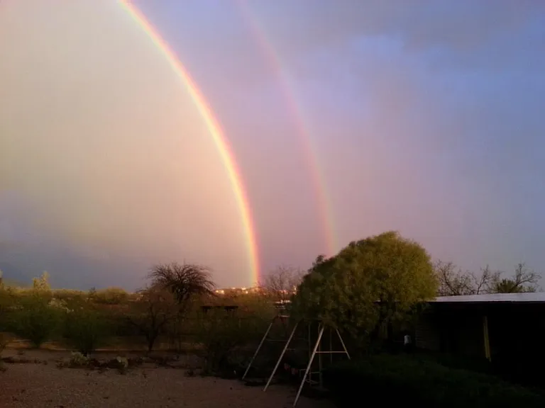 Full double rainbows over pool