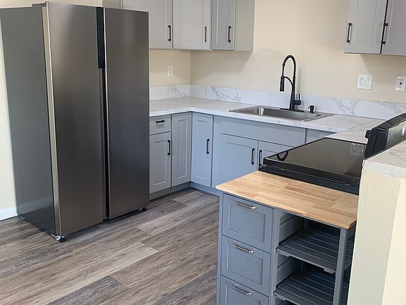 Newly renovated kitchen with new flooring, countertops, cabinetry, cooper plumbing, fresh paint, elegant faucet, new appliances and mobile island. Finished in oil-rubbed bronze.
