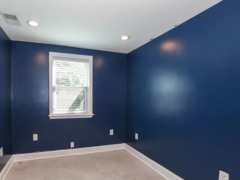 Spacious Bedroom with Deep Blue Accent Wall