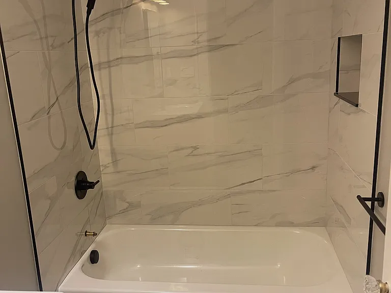 NEW BATH WITH CARRARA MARBLE AND NEW BLACK SHOWER FIXTURES PLUS HANDHELD SHOWER