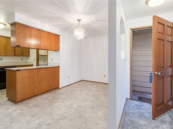 The entry is adjacent to the dining room and kitchen; ther is a porthole type cut-out in the seperating wall between the entry and dining room.