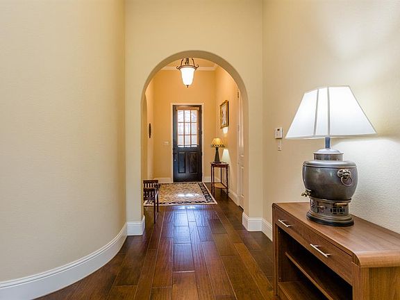 This home is beautifully built with gorgeous designer details including the handsome archways that are open to each room.