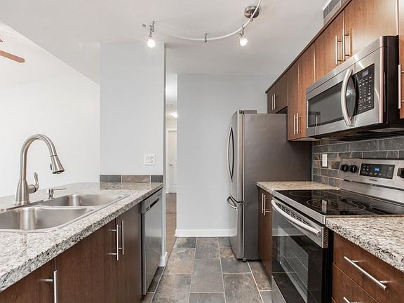 Open concept kitchen with stainless steel appliances and granite countertops