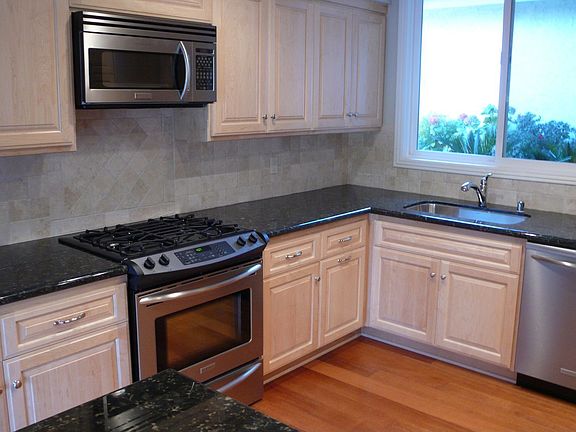 remodeled kitchen, stainless steel appliances, custom maple cabinets