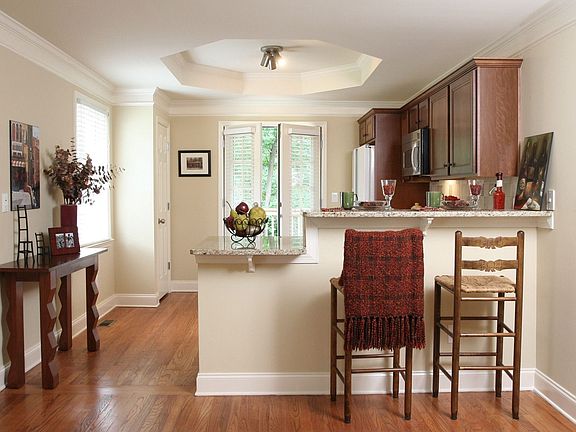 Renovated kitched with granite counters, breakfast bar and view to family room