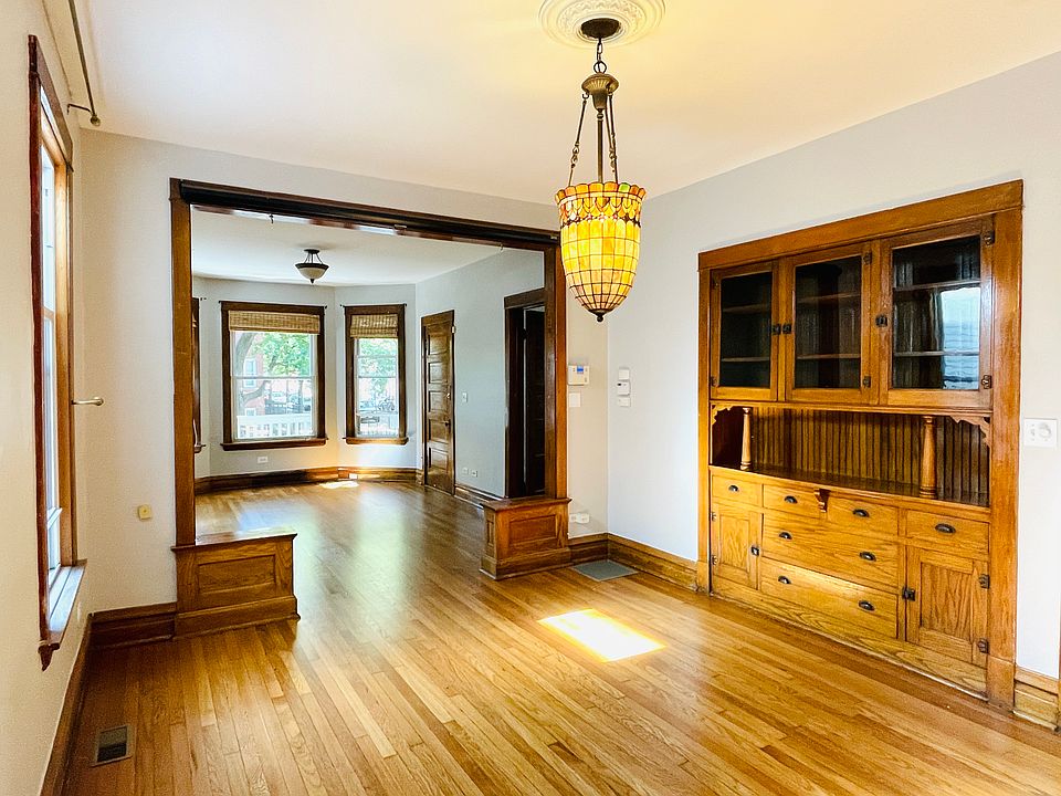 Dining Room with Tiffany chandelier and built-in cabinet.