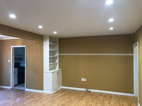 living room upon entry to house with new recessed lighting