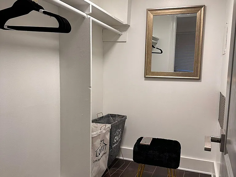 Walk-in Closet with mirror and dressing chair.