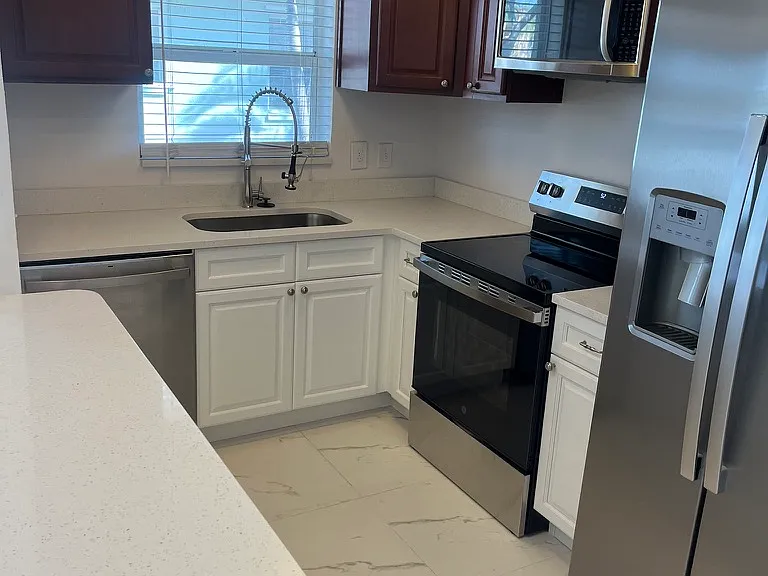 Stainless refrigerator with ice maker and water dispenser.