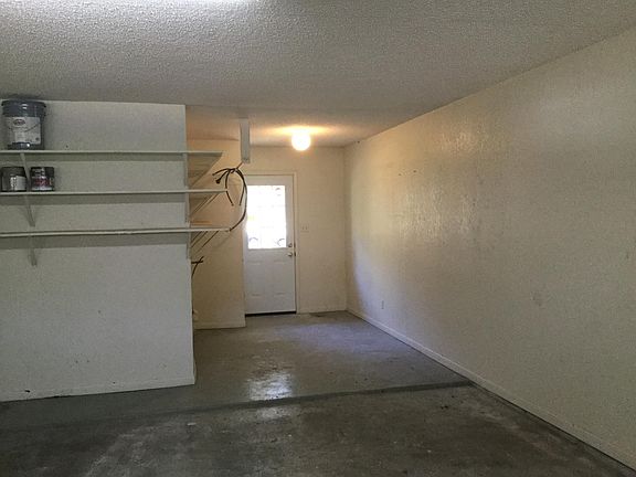 Laundry connections are in their separate area of the garage with a door to the back patio. Lots of shelves.