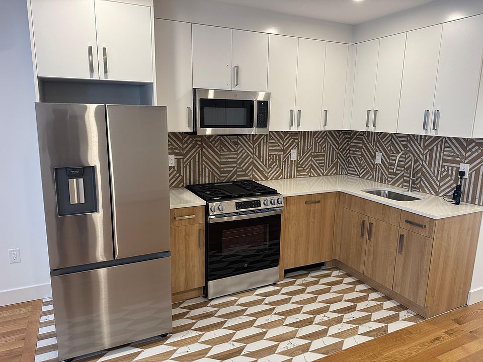Modern Kitchen with Granite counter top with stainless steel appliances includes Panel Dishwasher