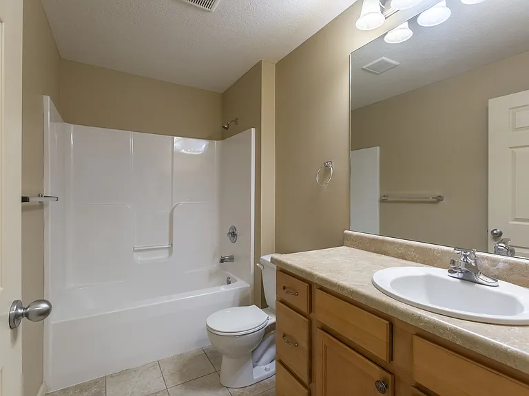Large bathroom with mirror at Square 131 12-Plex.
