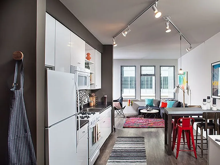 Classic Package I kitchen with white appliances, dark laminate countertops, white cabinetry, tile backsplash, and hard surface flooring