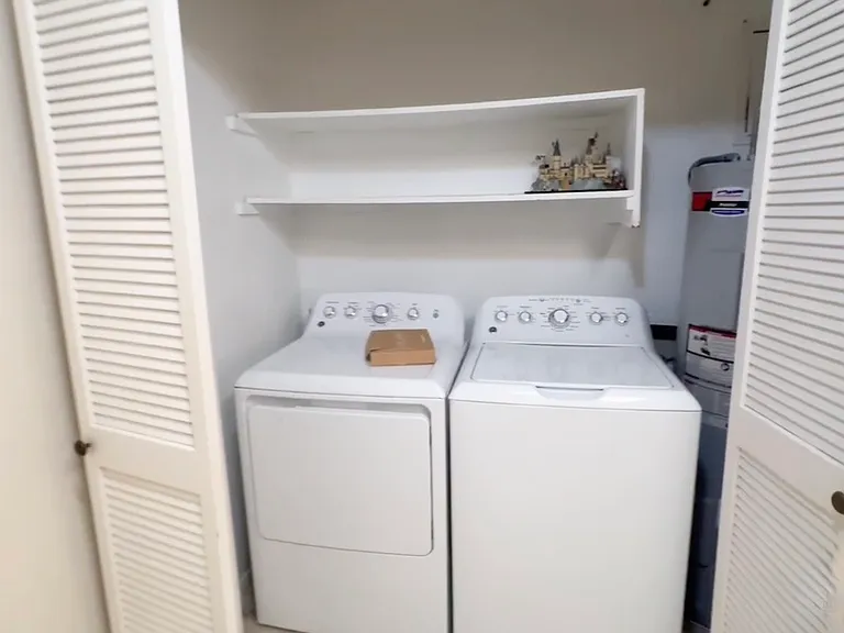 Laundry area with washer and dryer included.