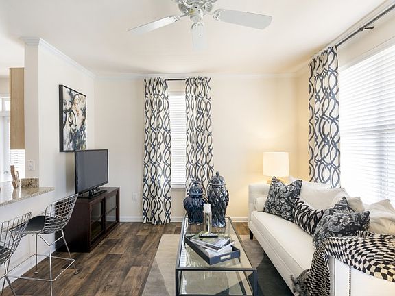 Living Room with wood-look flooring at Westwind Farms Apartm