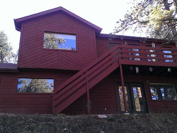 sun setting behind the house