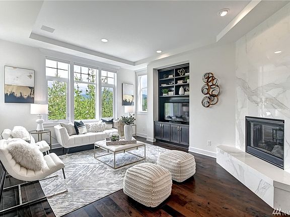 Inviting living room with view features gas fireplace with climate control and stunning fireplace surround.