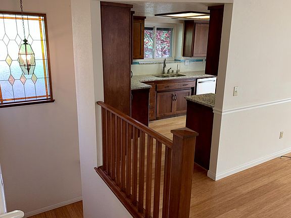 ascending the staircase to the living room and kitchen