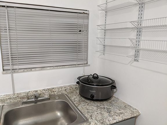 kitchen sink. Hanging storage shelves included in rent