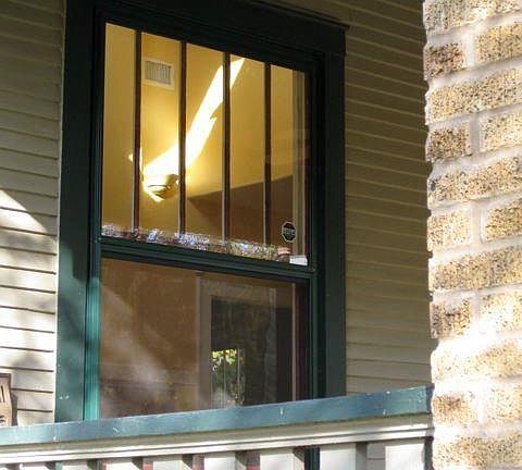 Craftsman original wooden windows retained, with storm windows for efficiency.