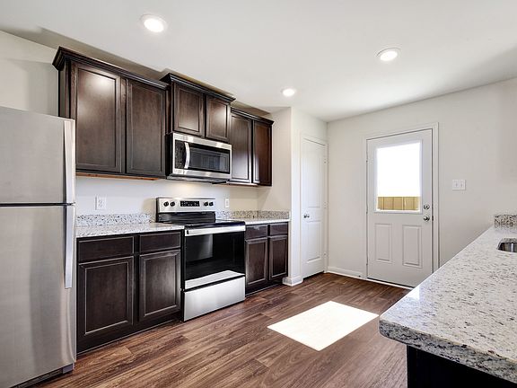 Enjoy stunning granite countertops and designer wood cabinetry in this kitchen.