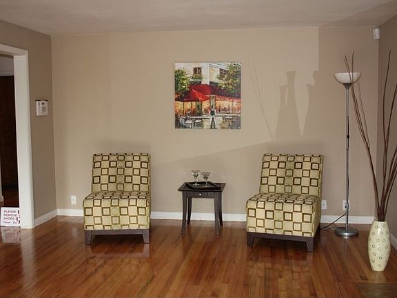 Large living room with refinished hardwood floors.