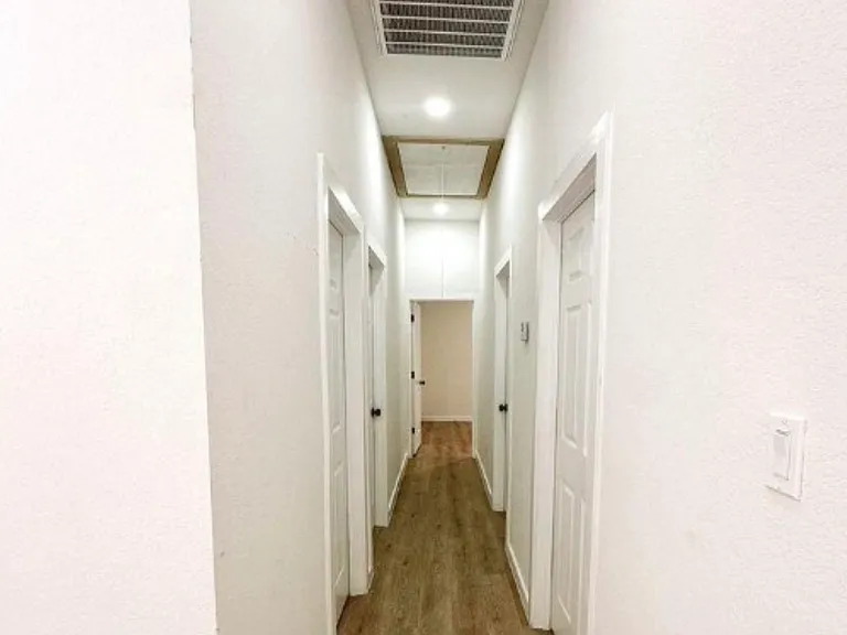 Hallway leading to Bedrooms, Laundry room and Restrooms.