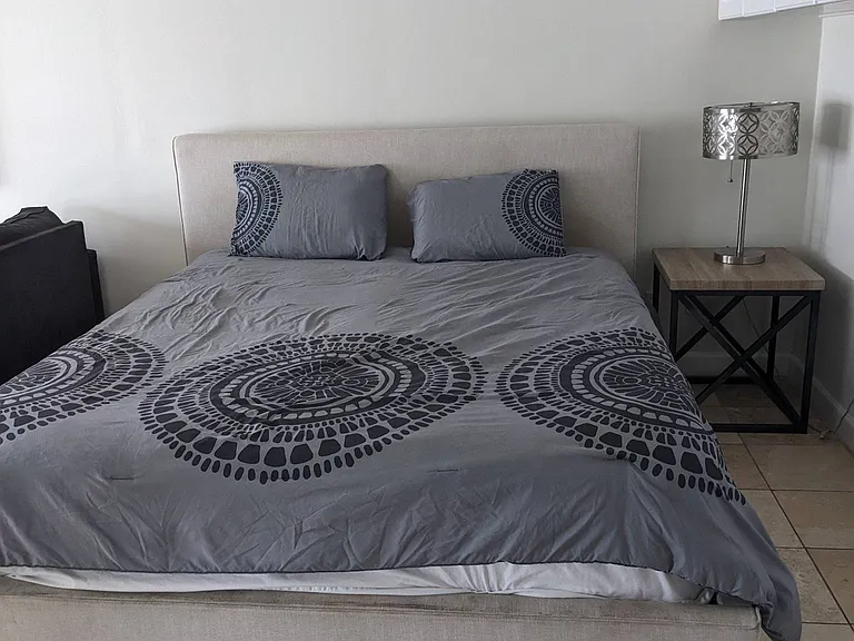 King size bed area with cabinets