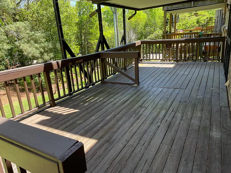 Private deck has covered and uncovered area with stairs to the yard