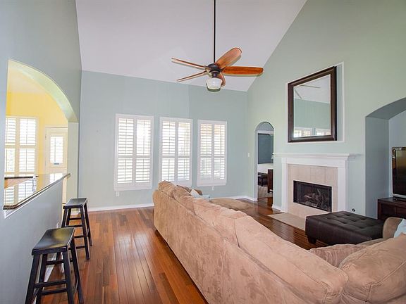 Living room with gas fire place, raised ceiling & recessed area for television.