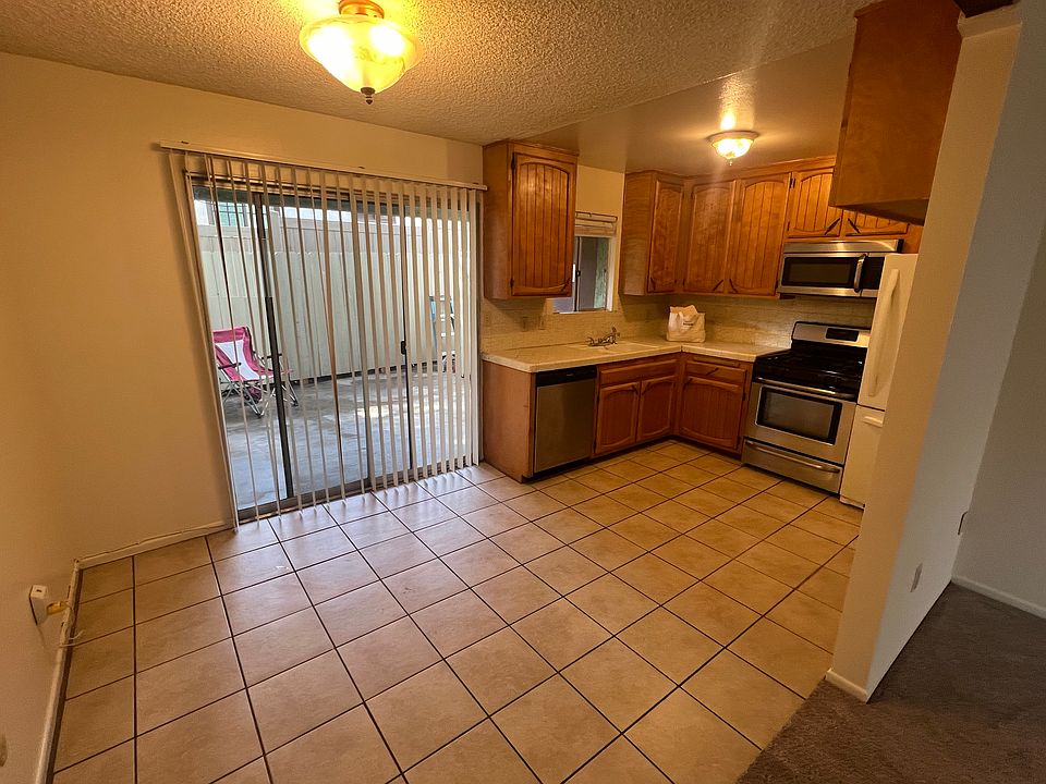 Fully equipped kitchen and dining area leading to enclosed covered patio