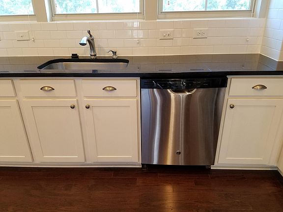 Stainless steel appliances. Farm-style sink.