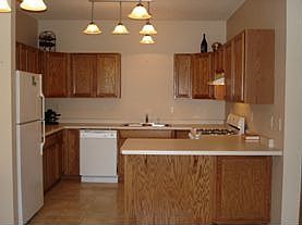 Kitchen offers upgraded lighting, plenty of storage space and a breakfast bar.