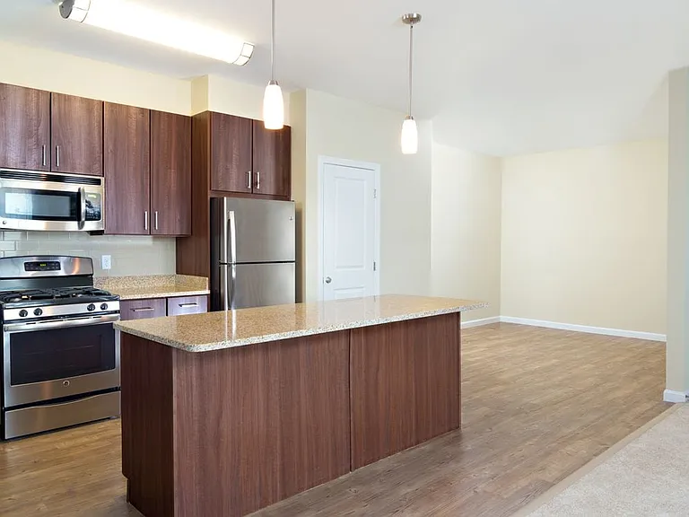 Classic Kitchen with chocolate pecan cabinetry, tile backsplash, laminate countertops, hard surface flooring, and stainless steel appliances
