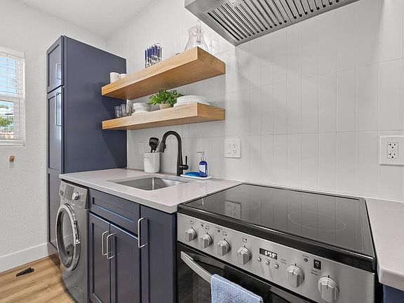 Kitchen window faces back yard space