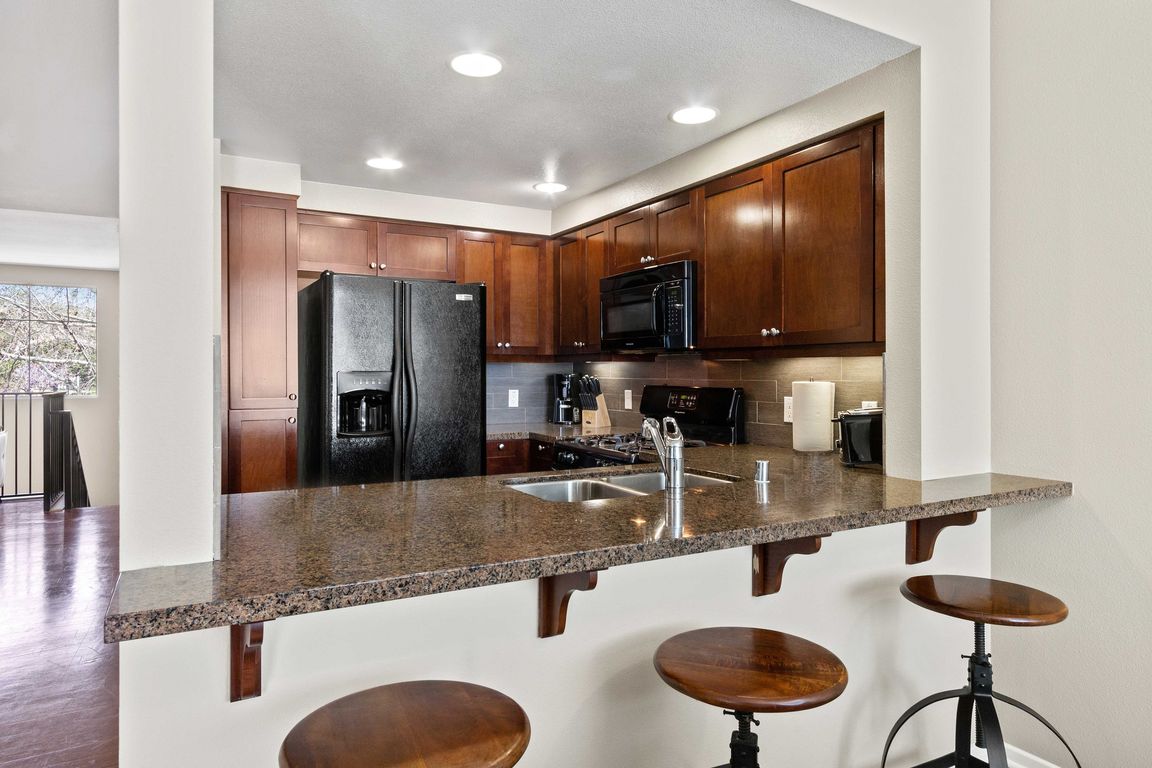 Kitchen with granite breakfast bar.