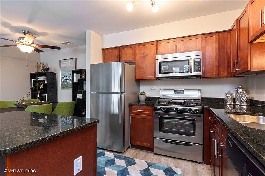 Large open kitchen with granite countertops and stainless-steel appliances