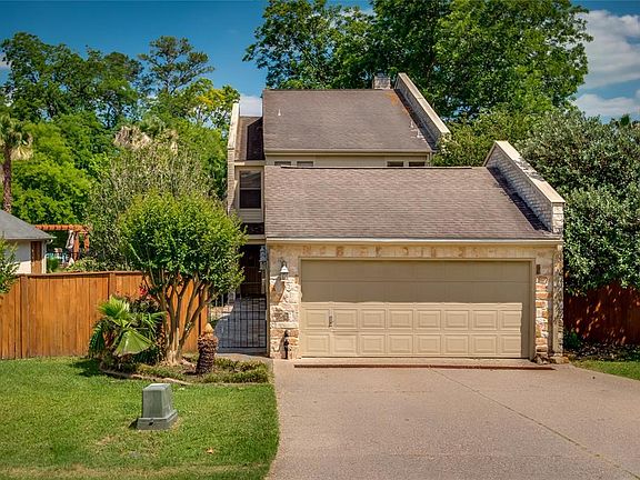 Here is the street view of this lovely home. Notice all of the landscaping and large trees in the back. It's also fenced.