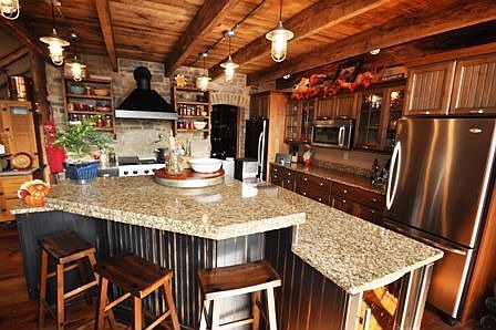 Kitchen - featuring knotty alder cabinetry with high end appliances. Viking 48" range, two built-in 