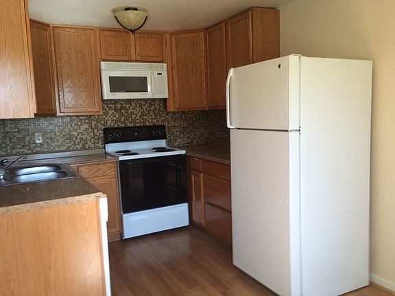 kitchen with granite countertops, hardwood floor, backsplash